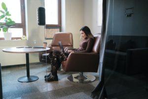 image shows woman in conference room handling contracts