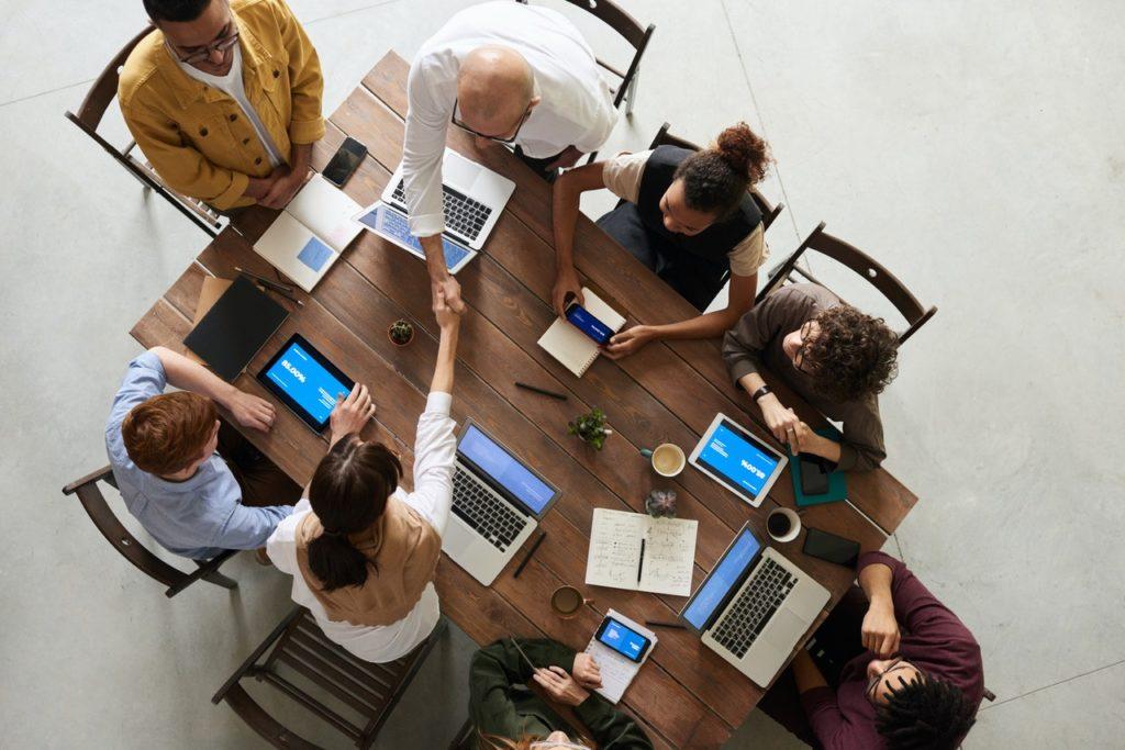 image shows people at a table negotiating