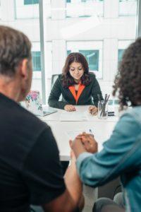 image shows woman writing legal contract