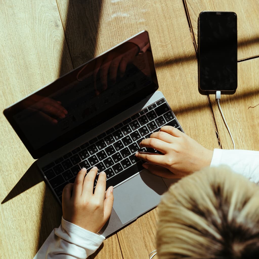 overhead view of person typing on laptop